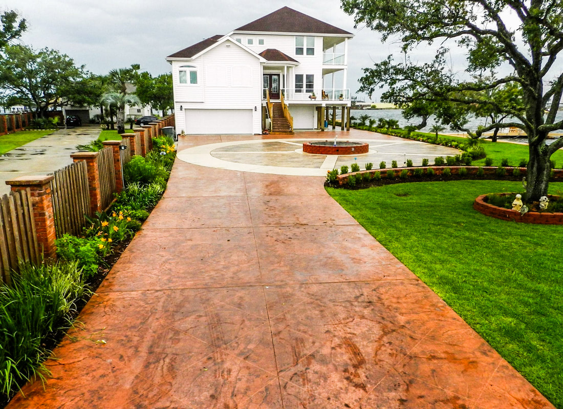 The back rear view of a new construction home with a covered up barbecue and patio furniture with a stamped concrete patio floor
